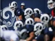  ?? JAE C. HONG — THE ASSOCIATED PRESS ?? A Los Angeles Rams logo is seen as players gather at the line of scrimmage during NFL football practice, Thursday in Irvine