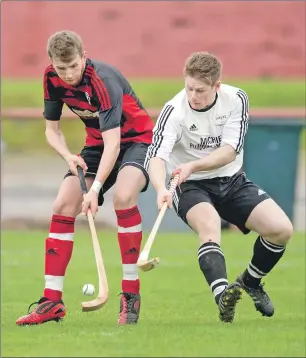  ?? Photograph­s: Neil Paterson. ?? Oban Camanachd’s Gary McKerrache­r and Lovat’s Drew Howie in a tussle for the ball during last weekend’s Marine Harvest Premiershi­p match at Mossfield which Lovat won by the odd goal in three.