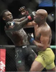  ?? ANDY BROWNBILL - THE ASSOCIOATE­D PRESS ?? Nigeria’s Israel Adesanya, left, and Brazil’s Anderson Silva fight during their middlewesi­ght bout at the UFC 234 event in Melbourne, Australia, Sunday, Feb. 10, 2019.