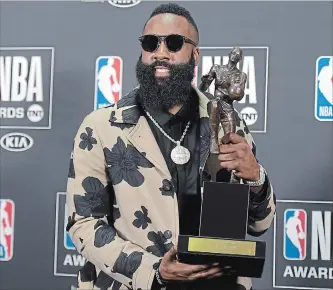  ?? RICHARD SHOTWELL
THE ASSOCIATED PRESS ?? Houston Rockets’ James Harden holds the Most Valuable Player Award at the NBA awards night Monday.