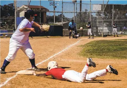  ?? ARIANA DREHSLER ?? A player on the North Park Jedi Little League team is safe at first base after trying to run to second in a game against The Coyotes at Morley Field in Balboa Park on Saturday.