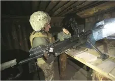  ??  ?? A Ukrainian serviceman loads a heavy machine gun at a position on the frontline with Russia backed separatist­s near Schastya, Lugansk region.