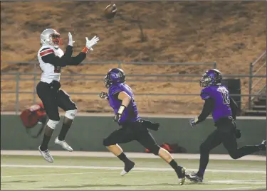  ?? BEA AHBECK/NEWS-SENTINEL ?? Lincoln's Merle Bass gets ready to catch the ball as Tokay's Joshua Kirchner pursues during their game at the Grape Bowl in Lodi on Friday.