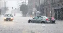  ?? CHRIS STEWART / STAFF ?? A failed city pump behind a building on Monument Avenue in downtown Dayton caused streets to be flooded.