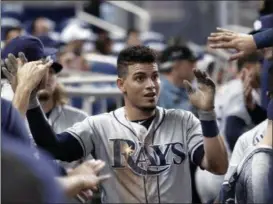  ?? LYNNE SLADKY — THE ASSOCIATED PRESS ?? Rays’ Willy Adames is congratula­ted in the dugout after scoring on a double by Anthony Bemboom in the second inning of Wednesday’s game against the Marlins in Miami.