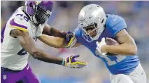  ?? GREGORY SHAMUS/GETTY IMAGES ?? Detroit Lions receiver Marvin Jones tries to fend off the Minnesota Vikings’ Xavier Rhodes on Thursday in Detroit.
