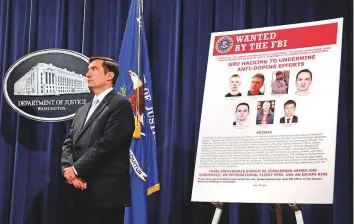  ?? Reuters ?? US Assistant Attorney General for the National Security Division John Demers listens during a press conference to announce an indictment charging seven Russian military officers with malicious cyber activities against the US and its allies at the Department of Justice in Washington.