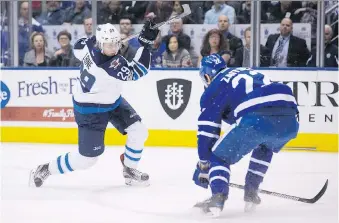  ?? CHRIS YOUNG/THE CANDIAN PRESS ?? Winnipeg Jets rookie Patrik Laine scores his team’s opening goal past Maple Leafs defenceman Nikita Zaitsev during first period action in Toronto on Tuesday night, adding to the three goals he scored the first time the Jets faced the Maple Leafs this...