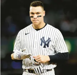  ?? ADAM HUNGER/AP ?? The Yankees’ Aaron Judge removes his batting gloves after the sixth inning of a game against the Orioles on Sept. 30 in New York.