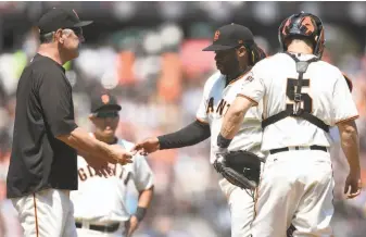 ?? Thearon W. Henderson / Getty Images ?? Giants manager Bruce Bochy takes the ball from starting pitcher Johnny Cueto, who didn’t enhance his potential trade value by allowing six runs in six innings against the Marlins.