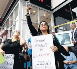  ?? Gary Coronado Los Angeles Times ?? ELVIRA HERRERA, center, and hundreds of others take part in the #MeToo Survivors’ March after a wave of sex scandals involving Hollywood figures.