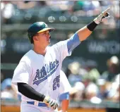  ??  ?? The Oakland Athletics’ Ryon Healy points to the crowd after hitting a solo home run during the second inning of Saturday’s 5-2 victory over the New York Yankees in Oakland.