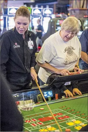  ?? NWA Democrat-Gazette/BEN GOFF ?? Casino worker Eva Rackleff (left) manages a craps table where Wendy Teach of Bentonvill­e was gambling on Aug. 23 at the Cherokee Casino &amp; Hotel in West Siloam Springs, Okla.
