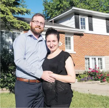  ?? RYAN REMIORZ / THE CANADIAN PRESS ?? Elena Trigiani and her husband, Thomas Poirier, paid 15 per cent above asking in a bidding war with six other bidders for their new home.