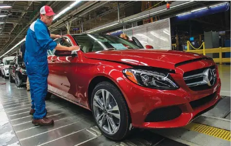  ?? ANDREW CABALLERO-REYNOLDS/AFP VIA GETTY IMAGES/TNS ?? In 2017, an employee does final inspection­s on a Mercedes-Benz C-Class at the Mercedes-Benz U.S. Internatio­nal factory in Vance, Ala.