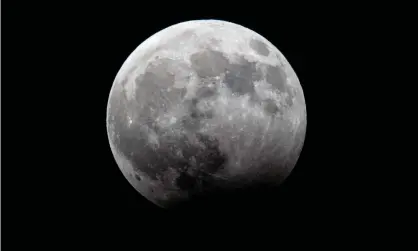  ?? Photograph: Jack Guez/ AFP/Getty Images ?? The moon during a partial lunar eclipse. Friday’s lunar eclipse will occur at moonrise for viewers in Australia.