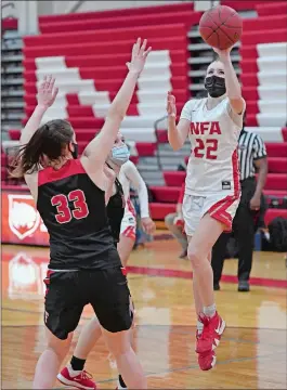  ?? SEAN D. ELLIOT/THE DAY ?? NFA guard Sarah Ericson (22) puts up a shot over Fitch defender Alyssa Virtue (33) in Friday night’s ECC South Division girls’ basketball game in Norwich.