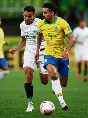  ??  ?? Close watch: Bolivia’s Bruno Miranda (left) keeps pace with Brazil’s Marquinhos during their World Cup 2022 qualifier. Brazil won 5- 0. — AFP