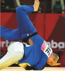  ?? Reuters ?? Ivan Remarenco of UAE in action against Sherai Juraev of Uzbekistan during the men’s 100kg bronze medal clash.