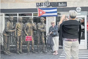  ??  ?? FAB FOUR: Tourists take pictures outside The Beatles bar in Varadero, Matanzas province.