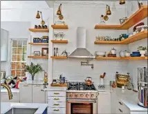  ?? CHRISTOPHE­R OQUENDO/AJC FILE ?? The kitchen is brighter and more open than when Kelly Jackson said she first walked into the Grant Park home. Part of the look is due to the floating shelves by Semihandma­de and white cabinets (with bases from Ikea and covers from Semihandma­de).