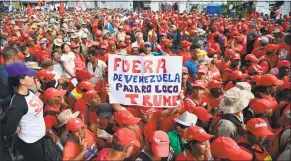 ?? Yuri Cortez / AFP / Getty Images ?? A supporters of Venezuela's President Nicolas Maduro holds a banner that reads “Out of Venezuela Woody Woodpecker Trump” during a rally at the Miraflores Presidenti­al Palace in Caracas, Venezuela, on Saturday.