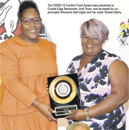  ??  ?? The COVID-19 Comfort Food Award was presented to Crystal Edge Restaurant, Irish Town, and accepted by coprincipa­ls Winsome Hall (right) and her sister Shreen Henry.