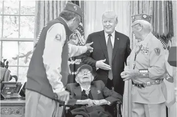  ?? — AFP photo ?? Trump greets Navajo veterans in the Oval Office of the White House during an event honouring Native American code talkers who served in World War II in Washington, DC.