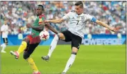  ?? Picture: GETTY IMAGES ?? POSSESSION BATTLE: Cameroon’s Christian Bassogog and Germany’s Julian Draxler during their Confederat­ions Cup match at the Fisht Olympic Stadium in Russia yesterday