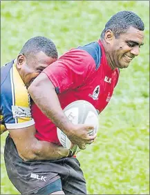  ?? Picture: SUPPLIED ?? Davujukia’s Jonetani Ralulu tries to fend off a Tuva Highlander­s player during the Nadroga rugby competitio­n this year. Davujukia Reds won 20-19.