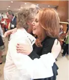  ?? NIKKI BOERTMAN / THE COMMERCIAL APPEAL ?? Cancer survivor Kathleen Nelson, left, a former St. Jude patient of Dr. Donald Pinkel, hugs Marlo Thomas, St. Jude National Outreach Director and daughter of founder Danny Thomas, during a ceremony to honor Pinkel and name a research tower after him.