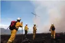  ?? Tasmania. Photograph: UFUA Tasmania ?? Firefighte­rs at the scene of a wildfire in