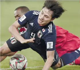  ?? AP FOTO ?? NEXT ROUND. Japan advanced to the next round after a 1-0 win over Oman.