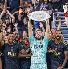  ?? RINGO H.W. CHIU/AP FILE ?? LAFC goalkeeper Maxime Crepeau holds up the Supporters Shield trophy after a match against Nashville SC on Oct. 9 in Los Angeles. Crepeau is almost fully healed from the broken leg that sent him to the hospital deep into extra time at the MLS Cup final late last year.