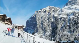  ?? CAMERON HEWITT ?? The Swiss village of Gimmelwald, under a blanket of snow high in the Alps, is a picturesqu­e place for winter festivitie­s.