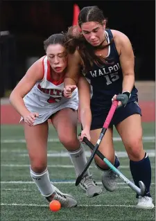  ?? CHRIS CHRISTO — BOSTON HERALD ?? Milton’s Mary Lovett, left, battles for the ball with Walpole’s Kerin Birch during a field hockey clash Wednesday. Walpole was a 7-0 winner.