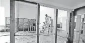  ?? DAVID J. PHILLIP, AP ?? Jose Martinez works to remove drywall from a home damaged by floodwater­s in Houston.