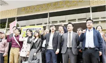  ?? — AFP photo ?? Pro-Taiwan independen­ce activists chant slogans outside the Taiwan High Court.