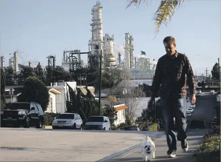  ?? Jay L. Clendenin Los Angeles Times ?? A CHEVRON oil refinery looms over El Segundo. The oil company has found an ally in labor groups in its lobbying on climate bills.