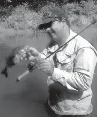  ?? Photo submitted by Alan Thomas ?? Bryan Hendricks holds up a smallmouth bass he caught Wednesday on the South Fork of the Spring River.