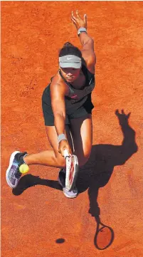  ?? JULIAN FINNEY GETTY IMAGES ?? Naomi Osaka of Japan stretches to play a backhand in her match against Patricia Maria Tig of Romania on Sunday.