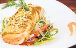  ?? JOSHUA BULMAN/COURTESY ?? The potato-wrapped, seared North Sea salmon is prepared with warm fennel slaw, pecans and shallot vinaigrett­e at the new Jasper’s on 18th west of Boca Raton.