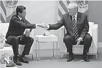  ?? AP Photo/Evan Vucci ?? President Donald Trump meets with Mexican President Enrique Pena Nieto on July 7 at the G20 Summit in Hamburg.