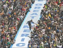  ?? [DAVID GRAHAM/THE ASSOCIATED PRESS] ?? Jimmie Johnson greets fans during driver introducti­ons before the Daytona 500 on Sunday. Drivers completed just 20 laps before rain forced a delay of more than two hours. The race will be finished Monday.