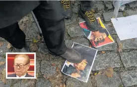  ?? Photos / AP ?? Protesters step on pictures of Xi Jinping. Inset, Jiang Zemin.