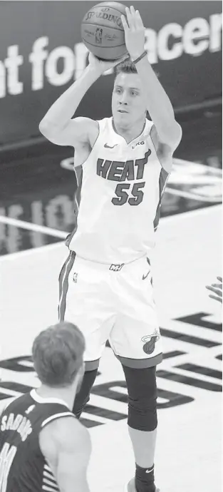  ?? AJ MAST/AP ?? Miami Heat guard Duncan Robinson (55) shoots in front of Indiana Pacers forward Domantas Sabonis (11) during the second half in Indianapol­is March 31.