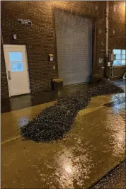  ?? PHOTO COURTESY OF UPPER GWYNEDD TOWNSHIP ?? Small berms made of gravel are piled in front of doors to the Upper Gwynedd wastewater treatment plant during heavy rains Sept. 1.