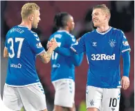  ??  ?? Scott Arfield with team-mate Steven Davis