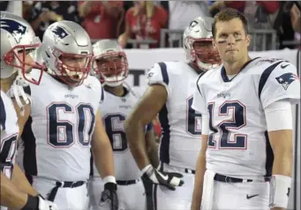  ??  ?? In this Oct. 5 file photo, New England Patriots quarterbac­k Tom Brady (right), waits to run onto the field with his teammates during team introducti­ons before an NFL football game against the Tampa Bay Buccaneers in Tampa, Fla. AP PHOTO/PHELAN M....