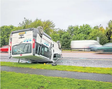  ??  ?? Passengers emerged unscathed after this van flipped over and landed on its roof on the A90 near The Horn.